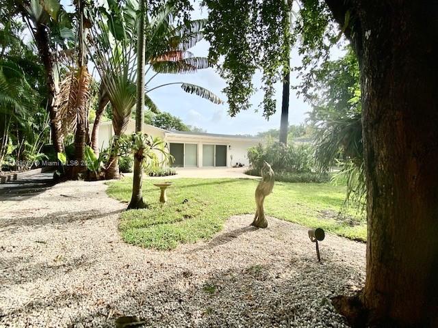 7772 Southwest 106th Terrace Pinecrest, FL 33156 - Photo 16 of 24 a view of a house with a backyard