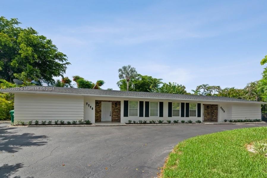 7772 Southwest 106th Terrace Pinecrest, FL 33156 - Photo 2 of 24 front view of a house with a patio