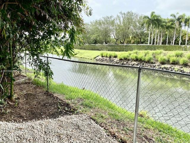 7772 Southwest 106th Terrace Pinecrest, FL 33156 - Photo 21 of 24 a view of a lake with a yard and large trees