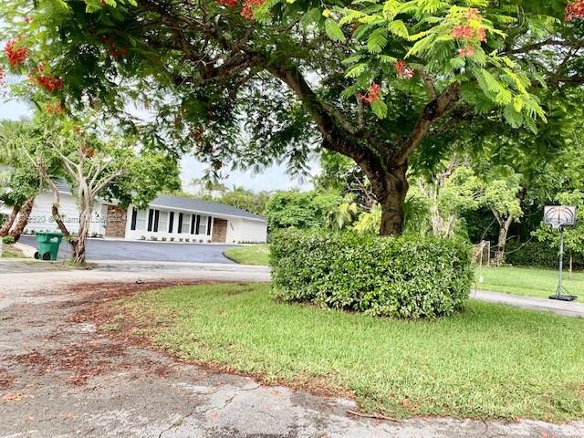 7772 Southwest 106th Terrace Pinecrest, FL 33156 - Photo 24 of 24 a front view of a house with a yard