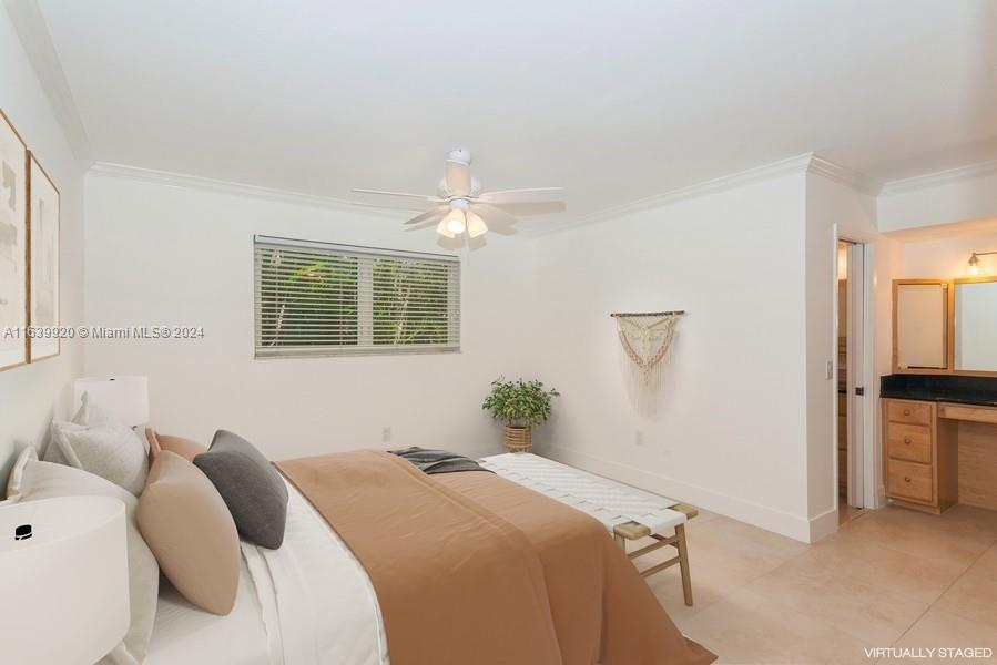 7772 Southwest 106th Terrace Pinecrest, FL 33156 - Photo 7 of 24 a bedroom with a bed and a chandelier