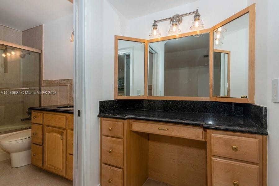 7772 Southwest 106th Terrace Pinecrest, FL 33156 - Photo 8 of 24 a bathroom with a granite countertop sink and a mirror