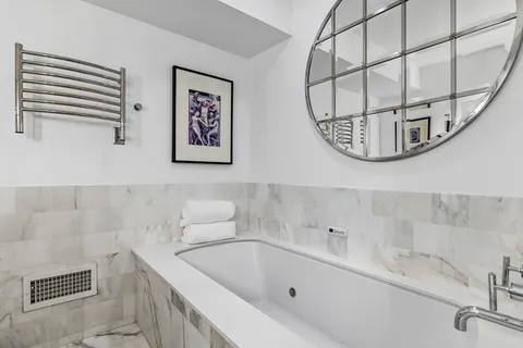 a bathroom with a bathtub and shower