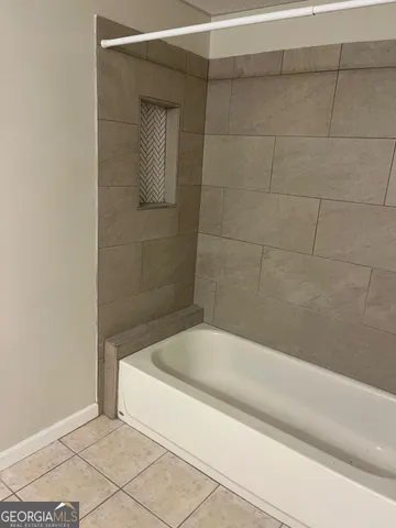 a bathroom with a granite countertop sink and a toilet