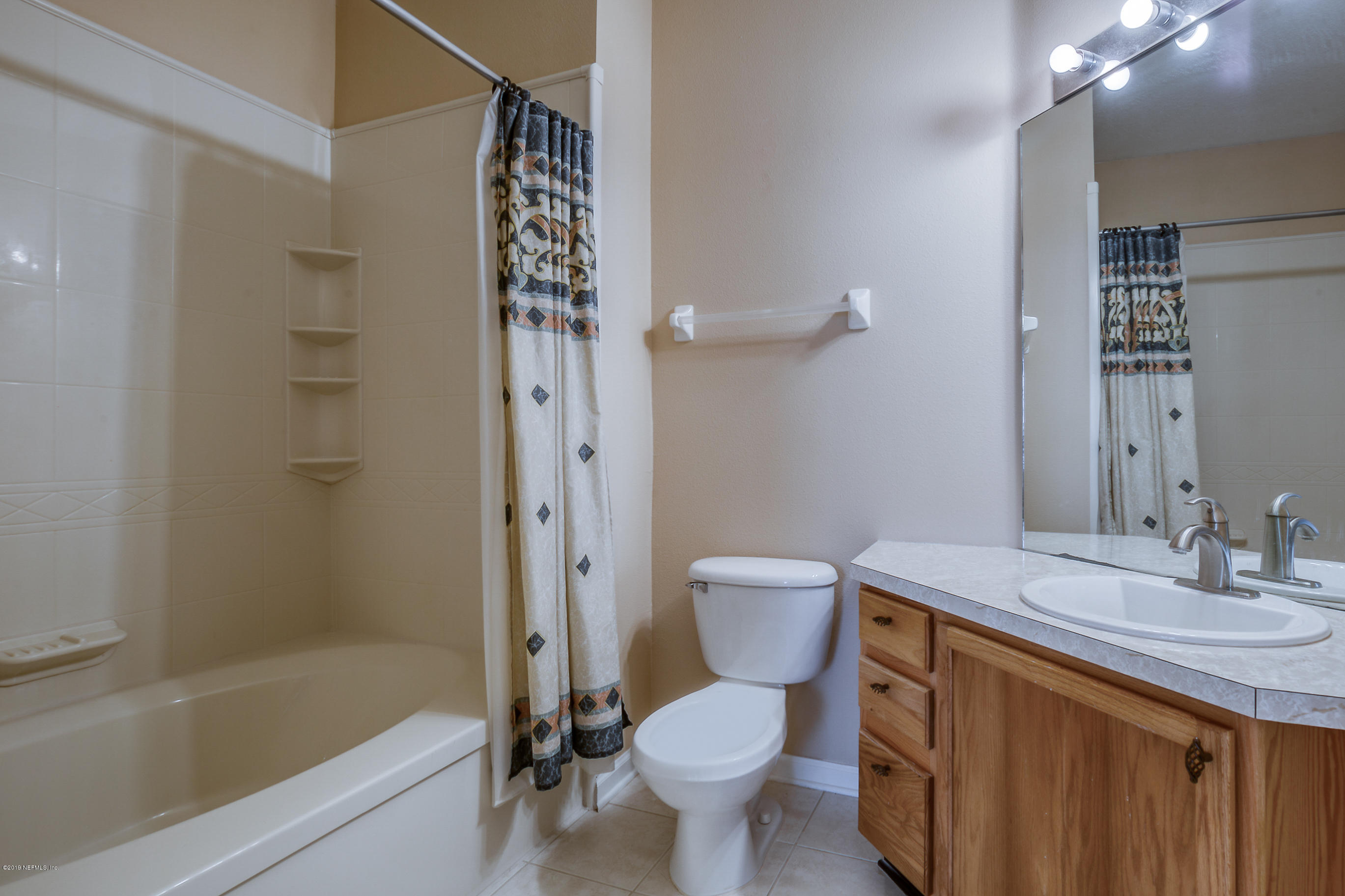 10550 Baymeadows Road, Unit 1023 Jacksonville, FL 32256 - Photo 10 of 42 a bathroom with a sink toilet vanity and shower