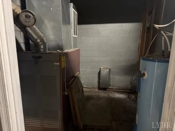 a view of an empty room with furniture and a window