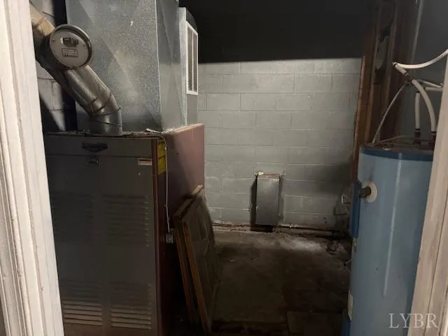 a view of an empty room with furniture and a window