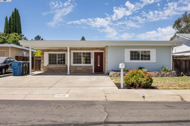 a house with a bench in front of house