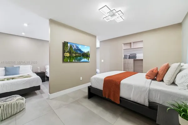 a bedroom with bed and a chandelier