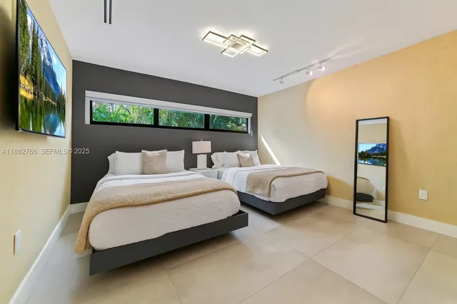 a spacious bedroom with a bed and a painting