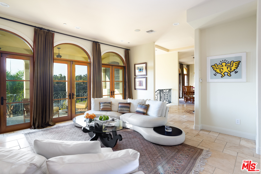 3110 Benedict Canyon Drive Beverly Hills, CA 90210 - Photo 12 of 45 a living room with furniture and a large window