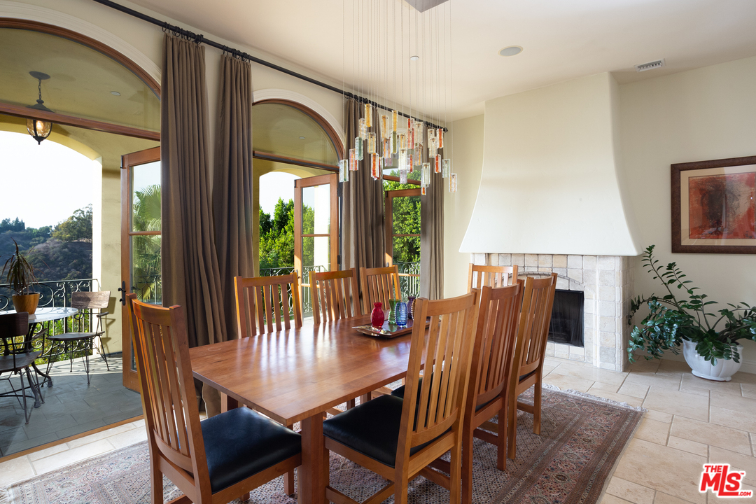 3110 Benedict Canyon Drive Beverly Hills, CA 90210 - Photo 13 of 45 a view of a dining room with furniture window and wooden floor
