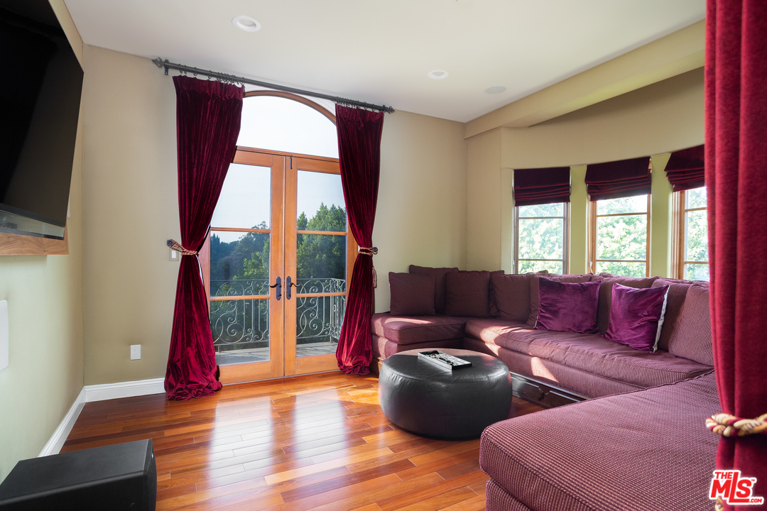 3110 Benedict Canyon Drive Beverly Hills, CA 90210 - Photo 18 of 45 a living room with furniture and a flat screen tv