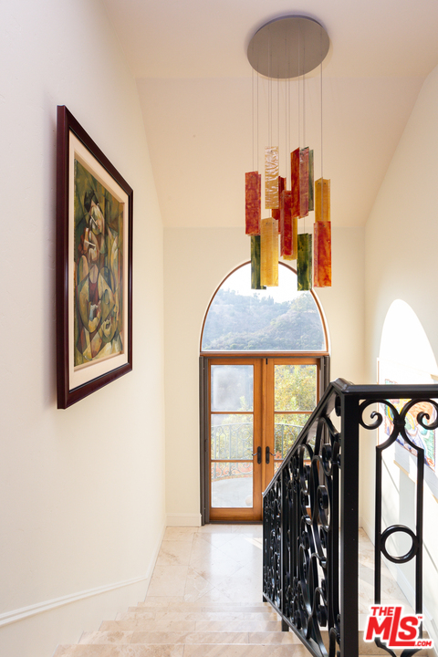 3110 Benedict Canyon Drive Beverly Hills, CA 90210 - Photo 19 of 45 a bedroom with a bed and a window