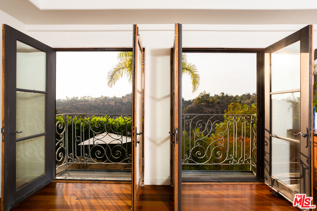 3110 Benedict Canyon Drive Beverly Hills, CA 90210 - Photo 21 of 45 a view of a floor to ceiling window in an empty room