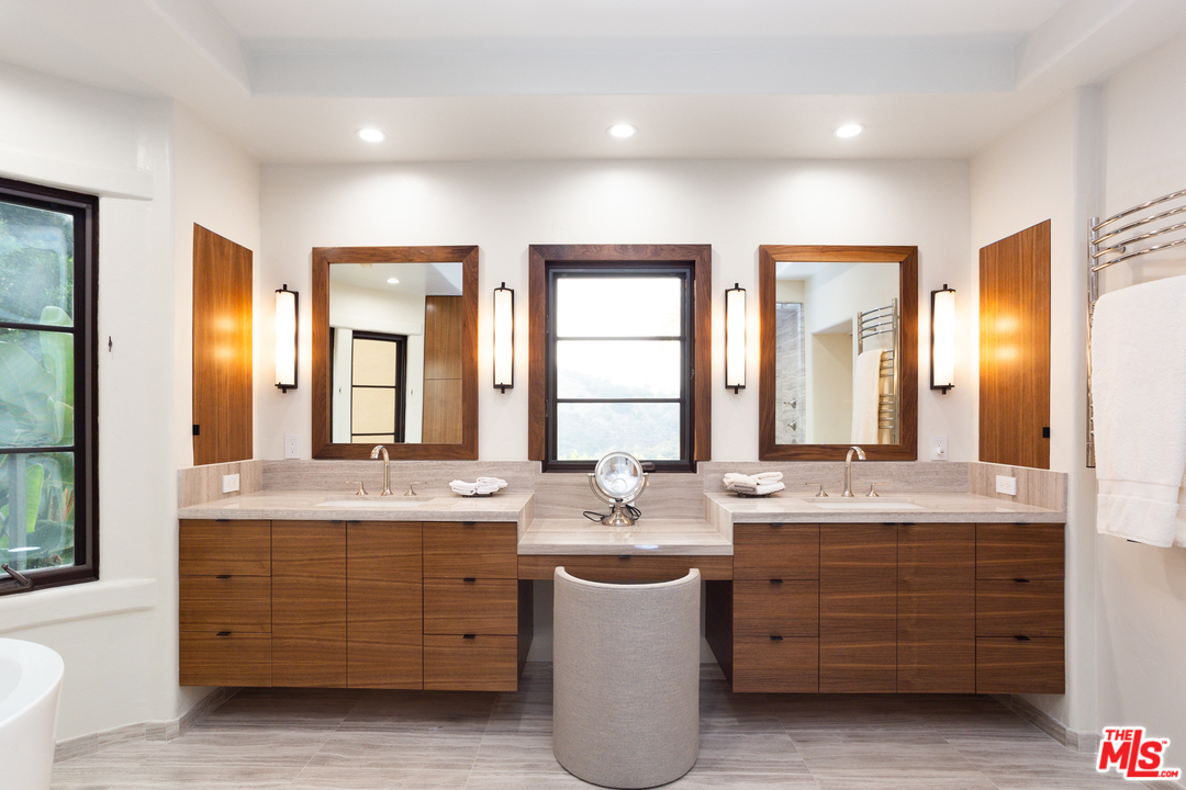 3110 Benedict Canyon Drive Beverly Hills, CA 90210 - Photo 24 of 45 a bathroom with a granite countertop double vanity sink mirror and