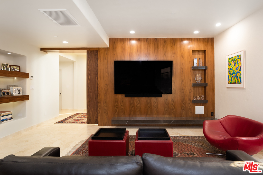 3110 Benedict Canyon Drive Beverly Hills, CA 90210 - Photo 30 of 45 a living room with furniture and a flat screen tv