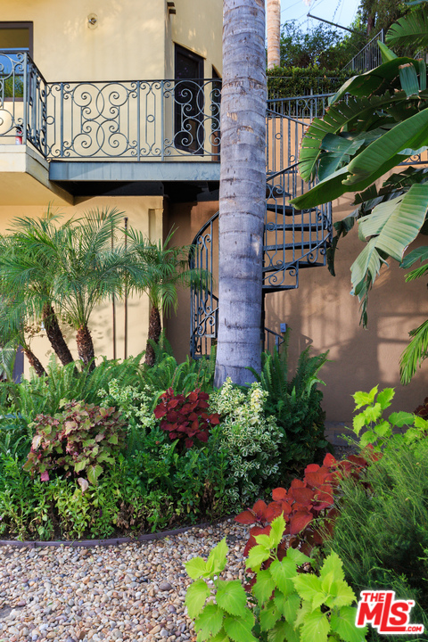 3110 Benedict Canyon Drive Beverly Hills, CA 90210 - Photo 39 of 45 a sign that is sitting in front of flowers
