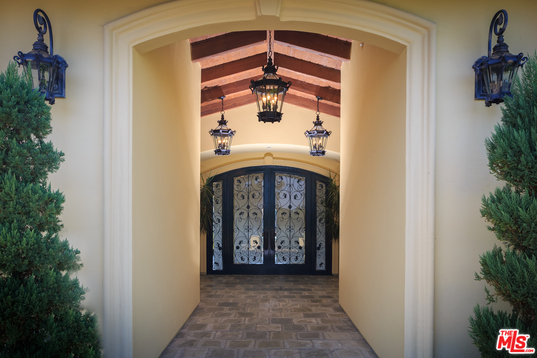 3110 Benedict Canyon Drive Beverly Hills, CA 90210 - Photo 6 of 45 a front view of a house with a porch
