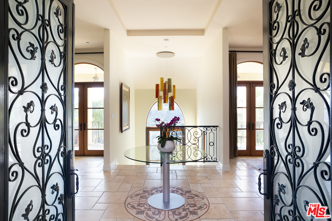 3110 Benedict Canyon Drive Beverly Hills, CA 90210 - Photo 7 of 45 a living room with furniture and a painting on the wall