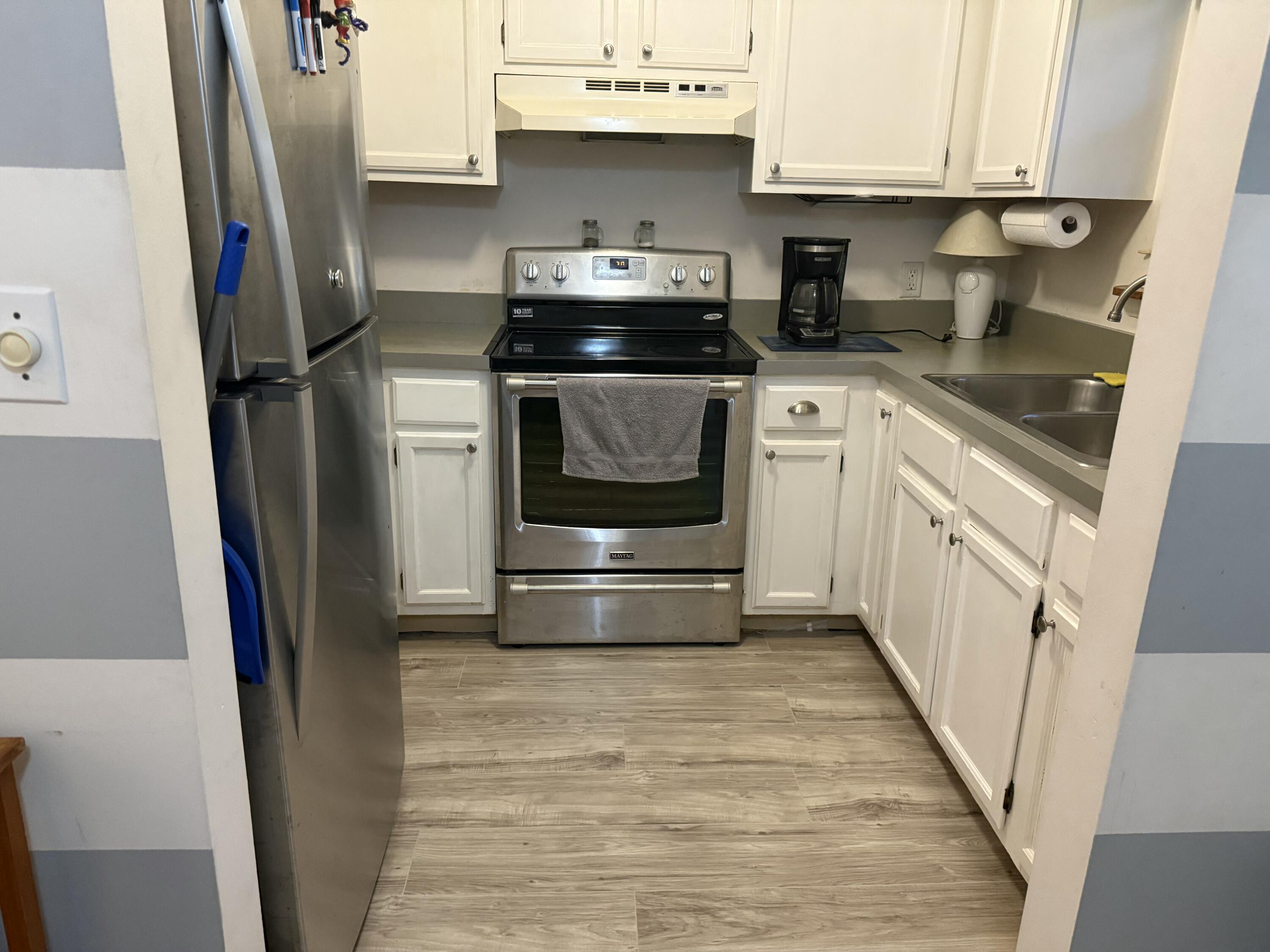 760 Musa Drive Key Largo, FL 33037 - Photo 19 of 20 a kitchen with stainless steel appliances a stove a refrigerator and cabinets