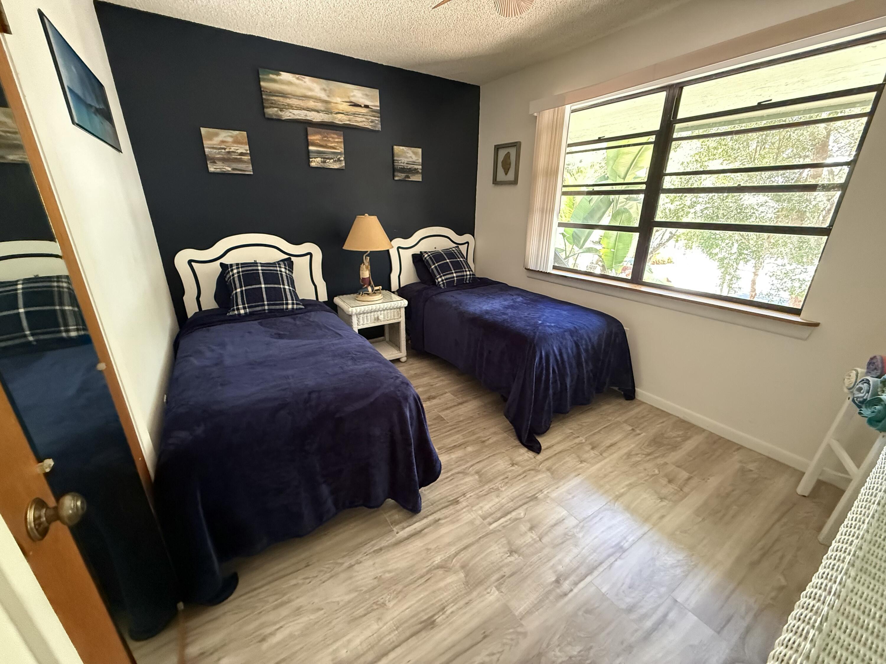 760 Musa Drive Key Largo, FL 33037 - Photo 8 of 20 a bedroom with two beds and a window