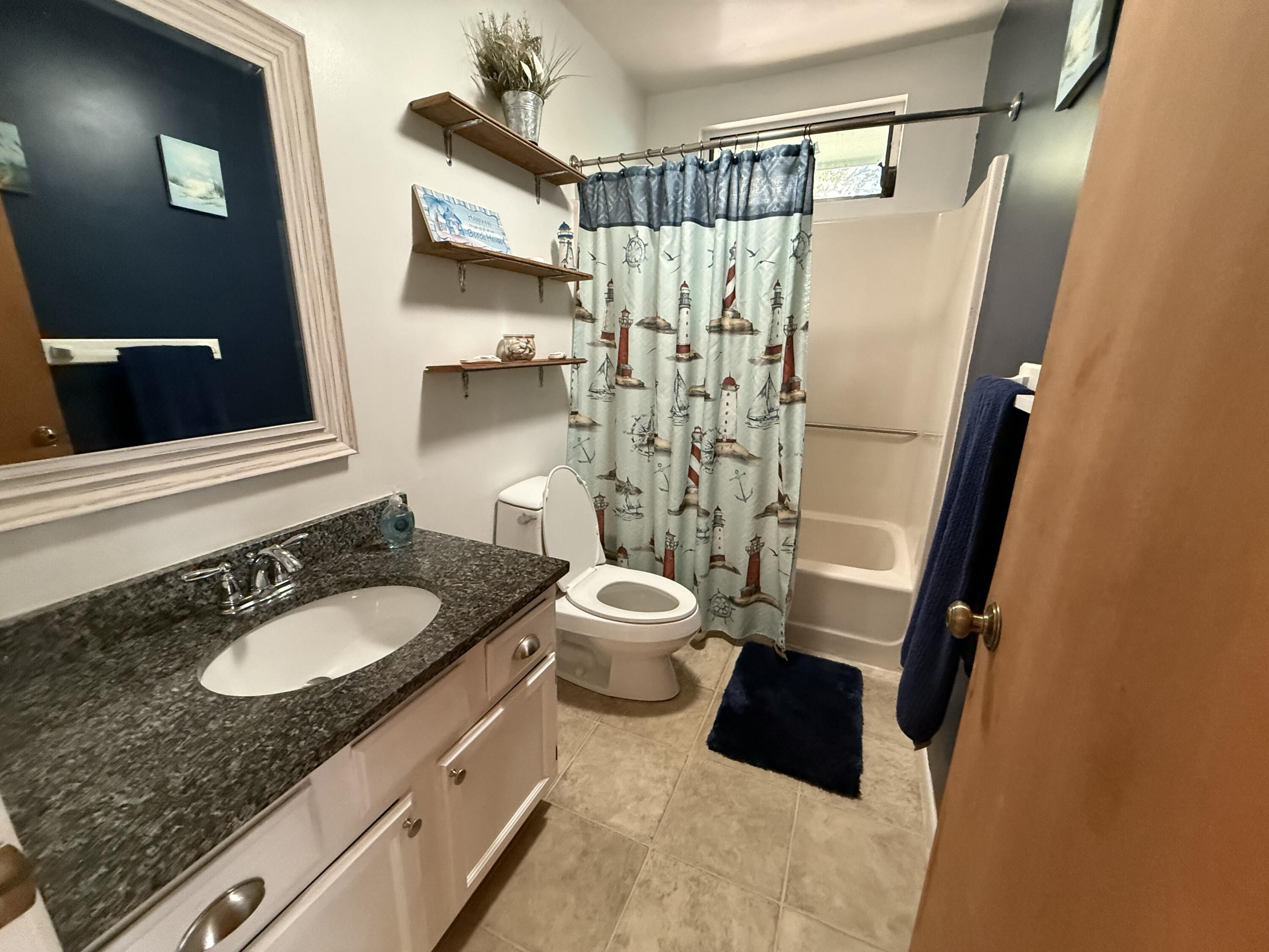 760 Musa Drive Key Largo, FL 33037 - Photo 9 of 20 a bathroom with a granite countertop sink toilet and shower
