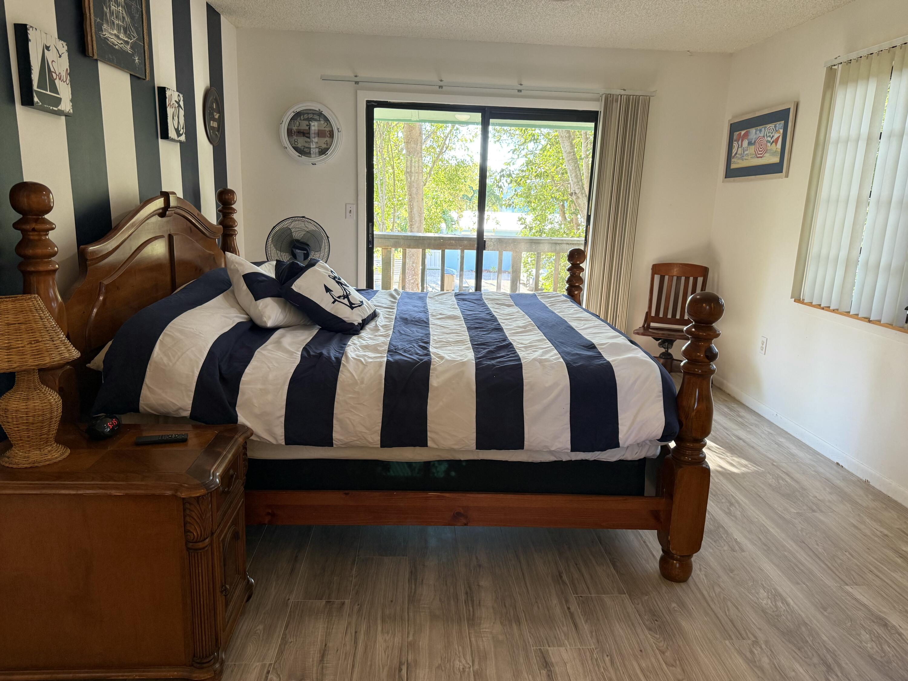 760 Musa Drive Key Largo, FL 33037 - Photo 10 of 20 a bedroom with a bed and wooden floor