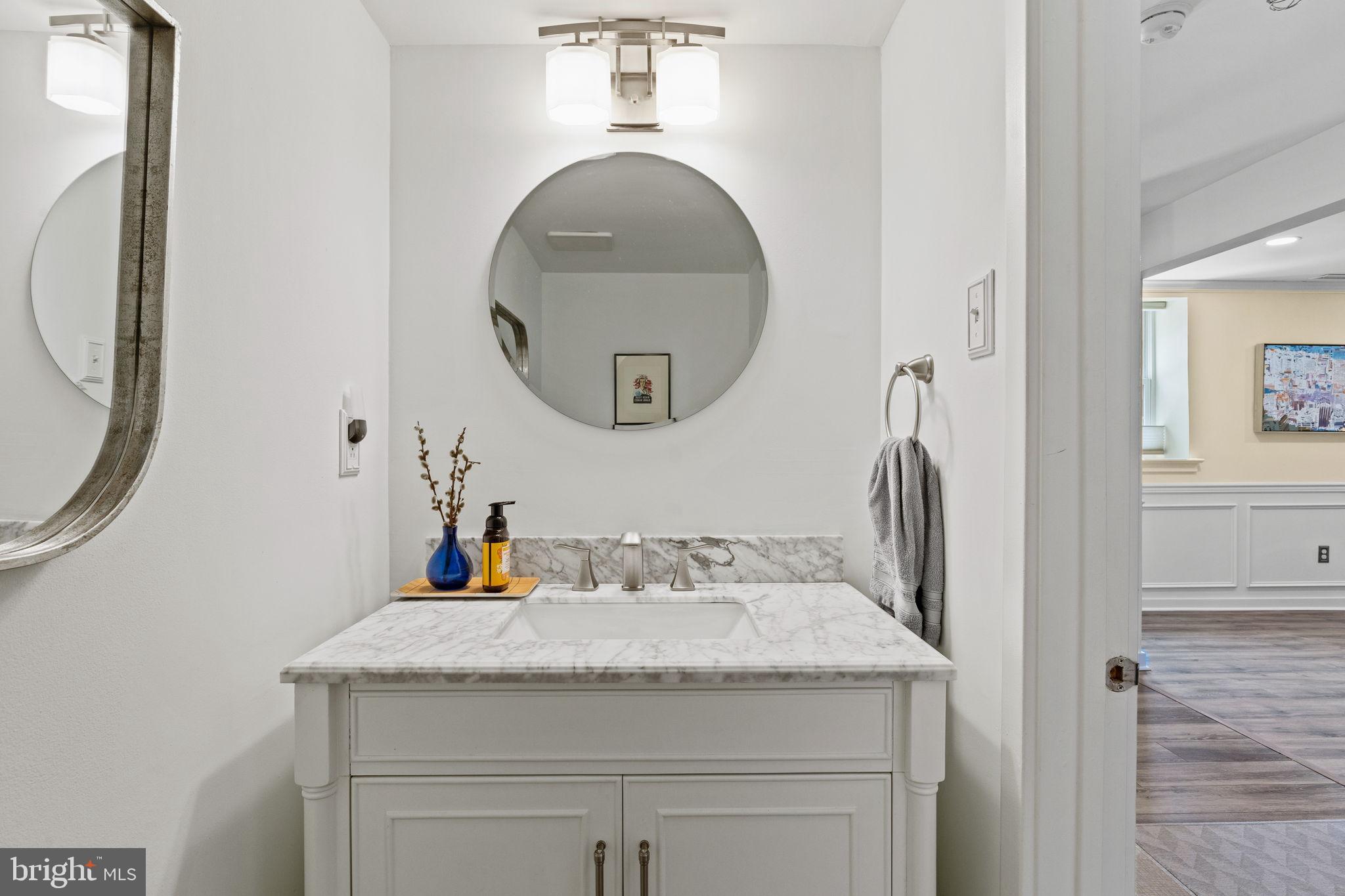 104 Woodside Road, Unit B106 Haverford, PA 19041 - Photo 13 of 31 a bathroom with a granite countertop sink and a mirror