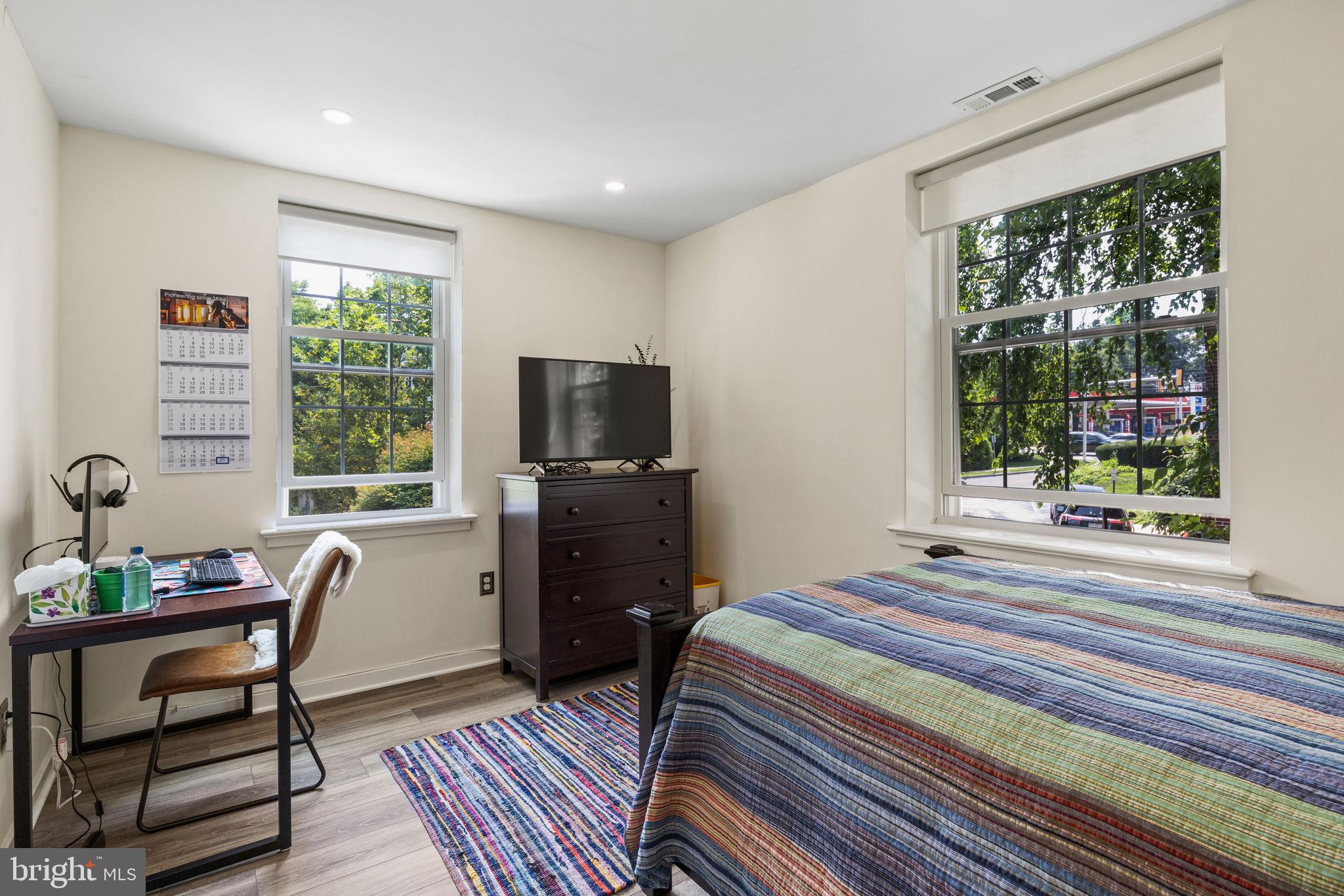 104 Woodside Road, Unit B106 Haverford, PA 19041 - Photo 25 of 31 a bedroom with a bed and large windows