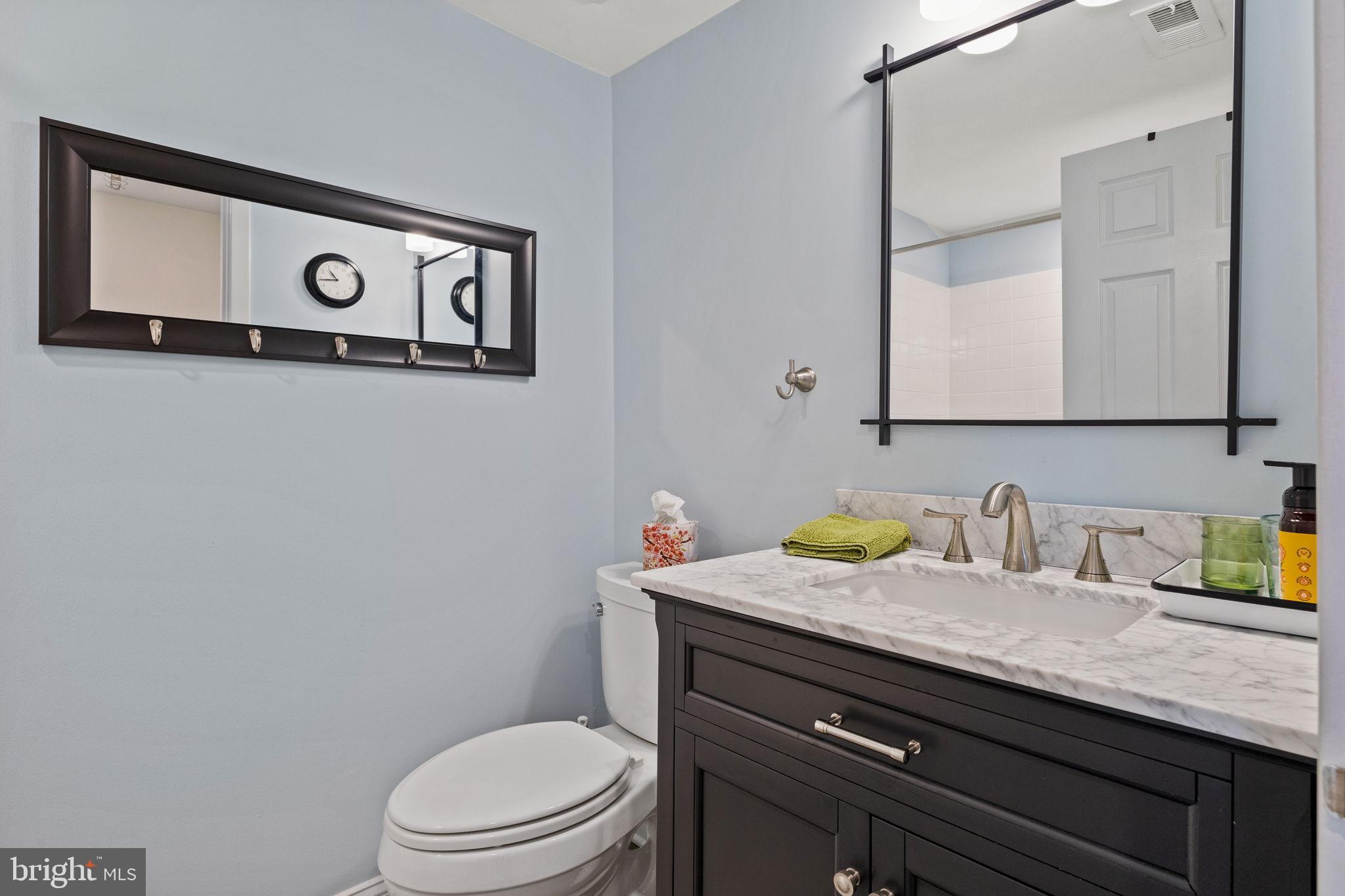 104 Woodside Road, Unit B106 Haverford, PA 19041 - Photo 27 of 31 a bathroom with a granite countertop toilet sink and mirror