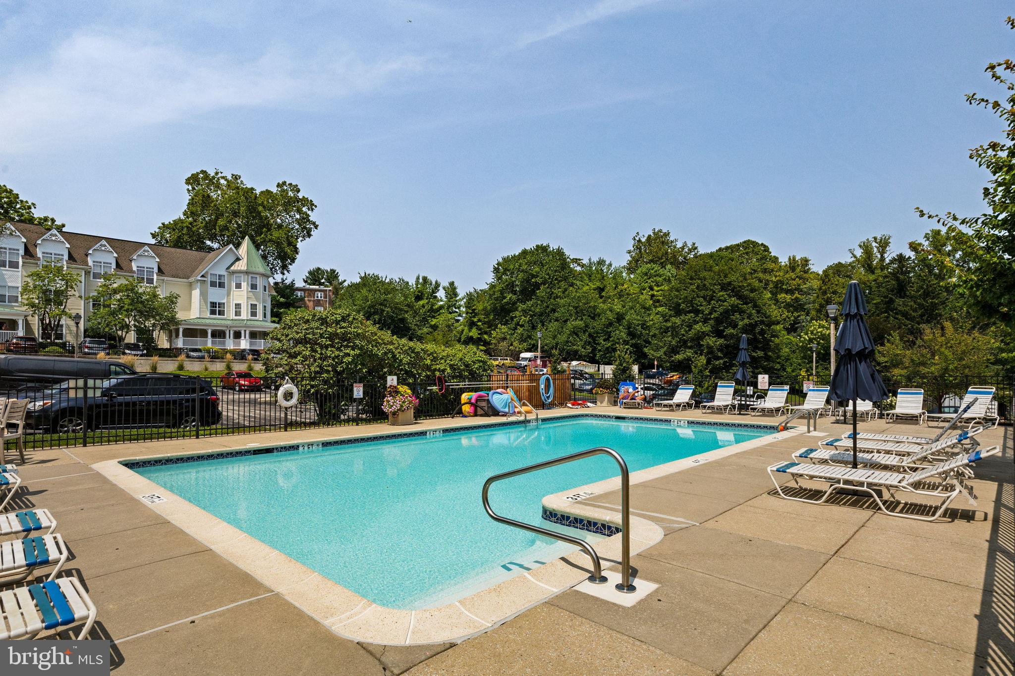 104 Woodside Road, Unit B106 Haverford, PA 19041 - Photo 30 of 31 a view of a swimming pool with lounge chairs