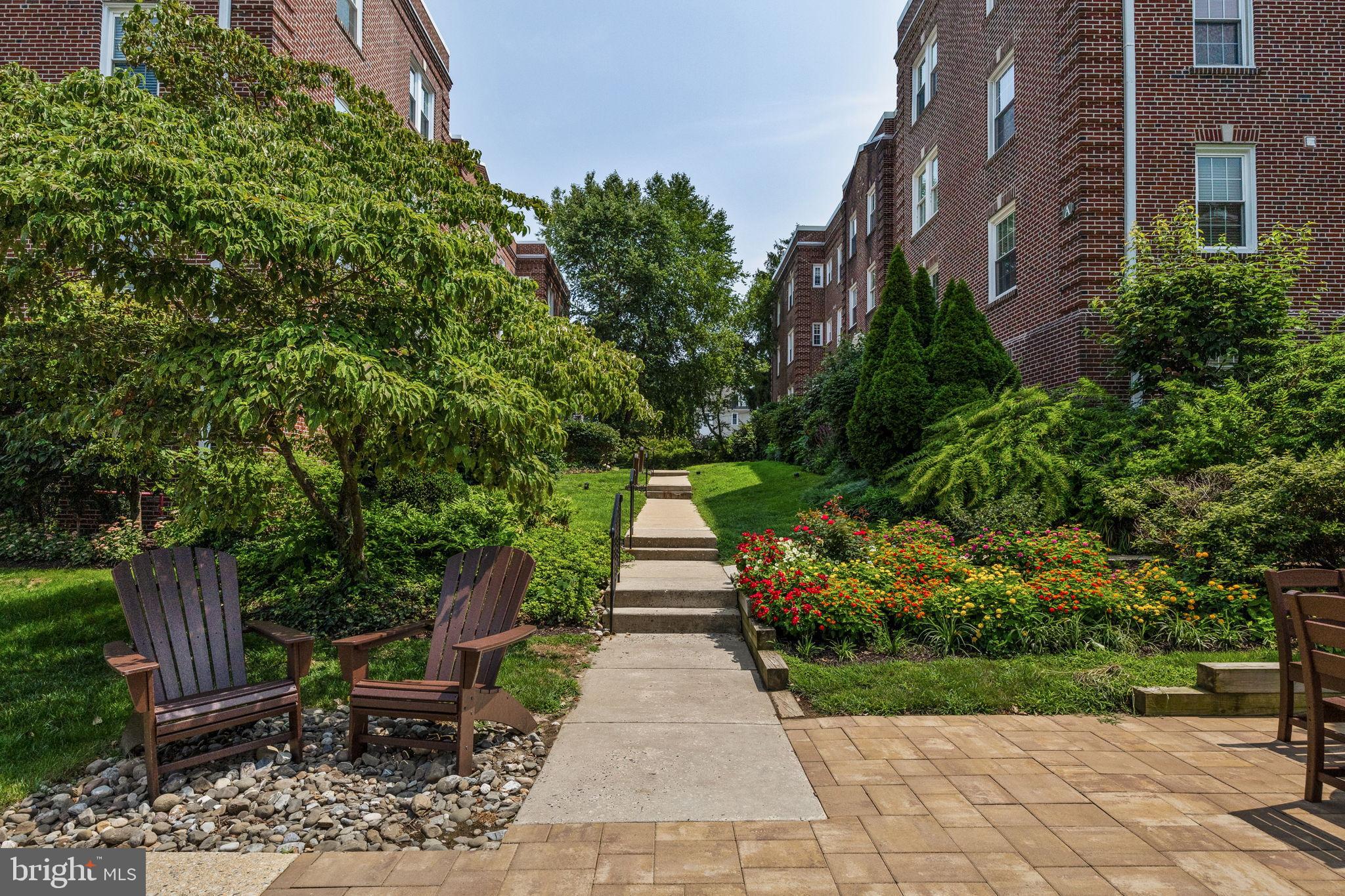 104 Woodside Road, Unit B106 Haverford, PA 19041 - Photo 31 of 31 a view of a patio with table and chairs and potted plants