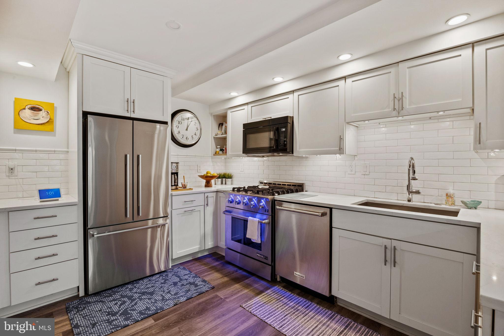 104 Woodside Road, Unit B106 Haverford, PA 19041 - Photo 10 of 31 a kitchen with stainless steel appliances granite countertop a refrigerator and a sink