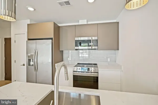 a kitchen with stainless steel appliances a refrigerator stove and sink