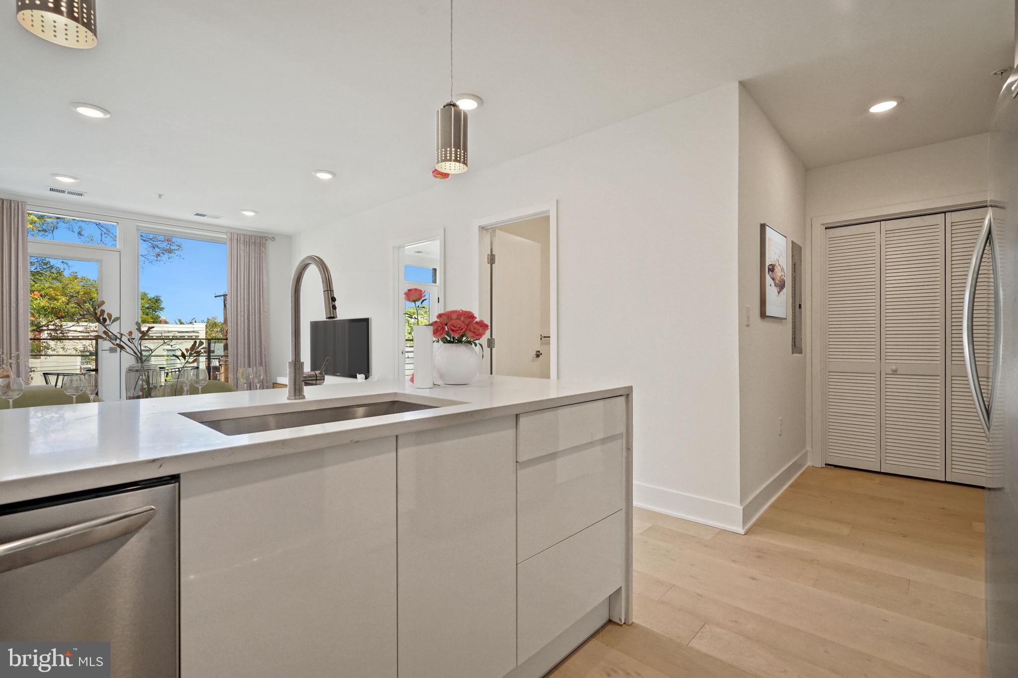 2027 Rhode Island Avenue Northeast, Unit 401 Washington, DC 20018 - Photo 12 of 29 a kitchen with stainless steel appliances a sink and a refrigerator