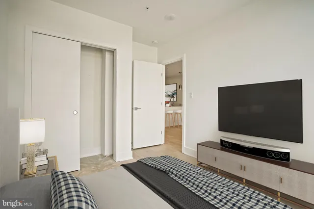 a bedroom with bed and flat screen tv