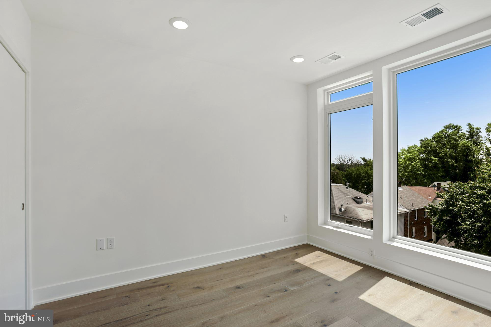 2027 Rhode Island Avenue Northeast, Unit 401 Washington, DC 20018 - Photo 18 of 29 a view of an empty room with a window