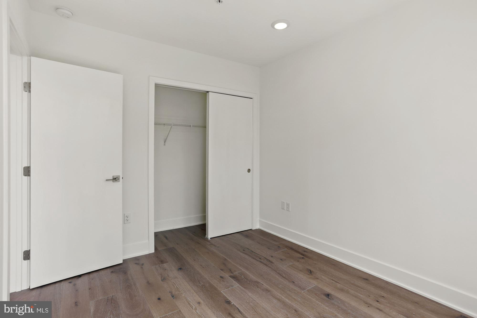 2027 Rhode Island Avenue Northeast, Unit 401 Washington, DC 20018 - Photo 20 of 29 a view of an empty room with wooden floor