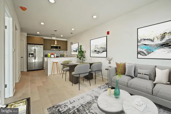 a living room with furniture and kitchen view