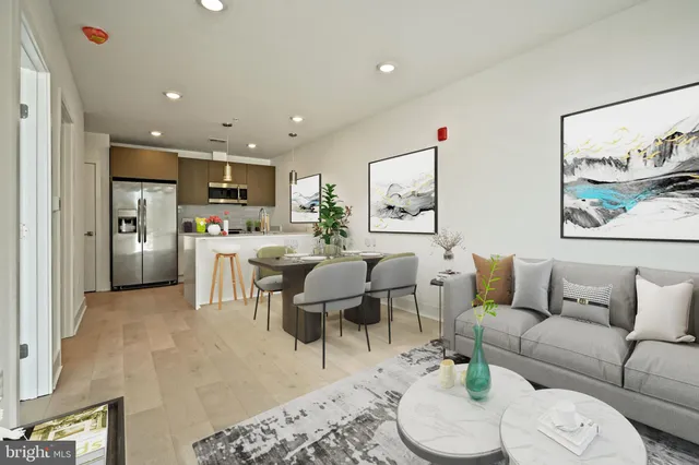 a living room with furniture and kitchen view