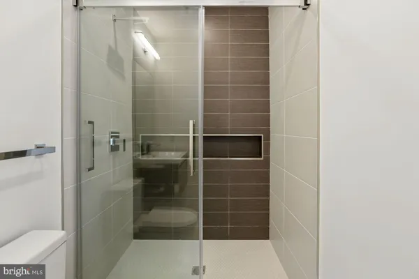 a bathroom with a shower and toilet