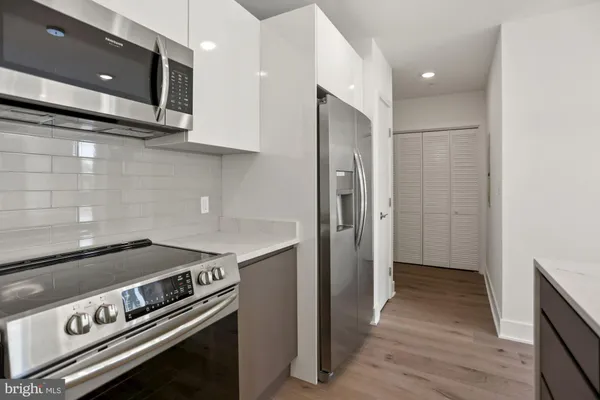 a kitchen with a stove and a microwave