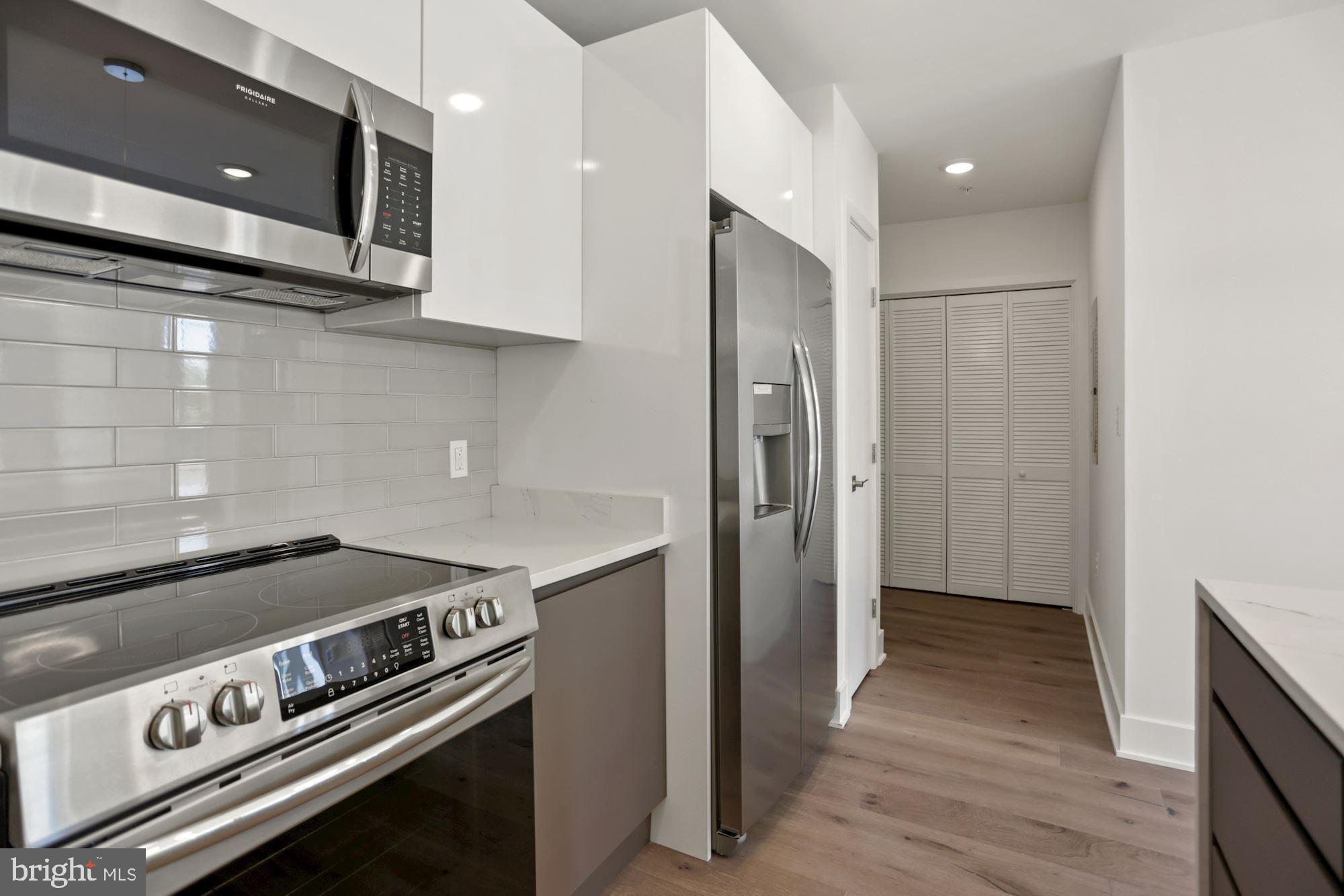 2027 Rhode Island Avenue Northeast, Unit 401 Washington, DC 20018 - Photo 5 of 29 a kitchen with a stove and a microwave