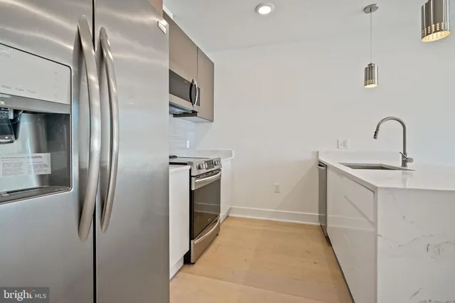 a kitchen with stainless steel appliances a refrigerator and a sink