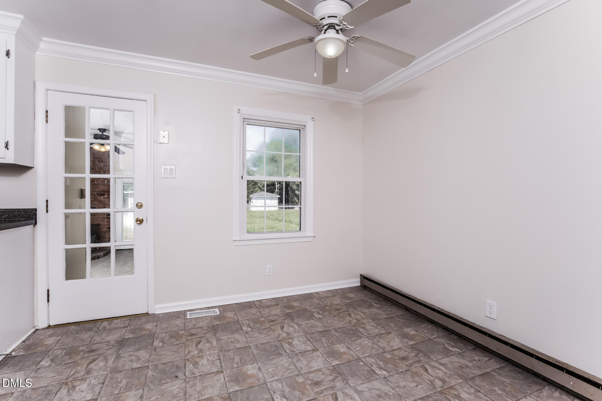 870 Abbott Road Henderson, NC 27537 - Photo 8 of 20 an empty room with windows and fan