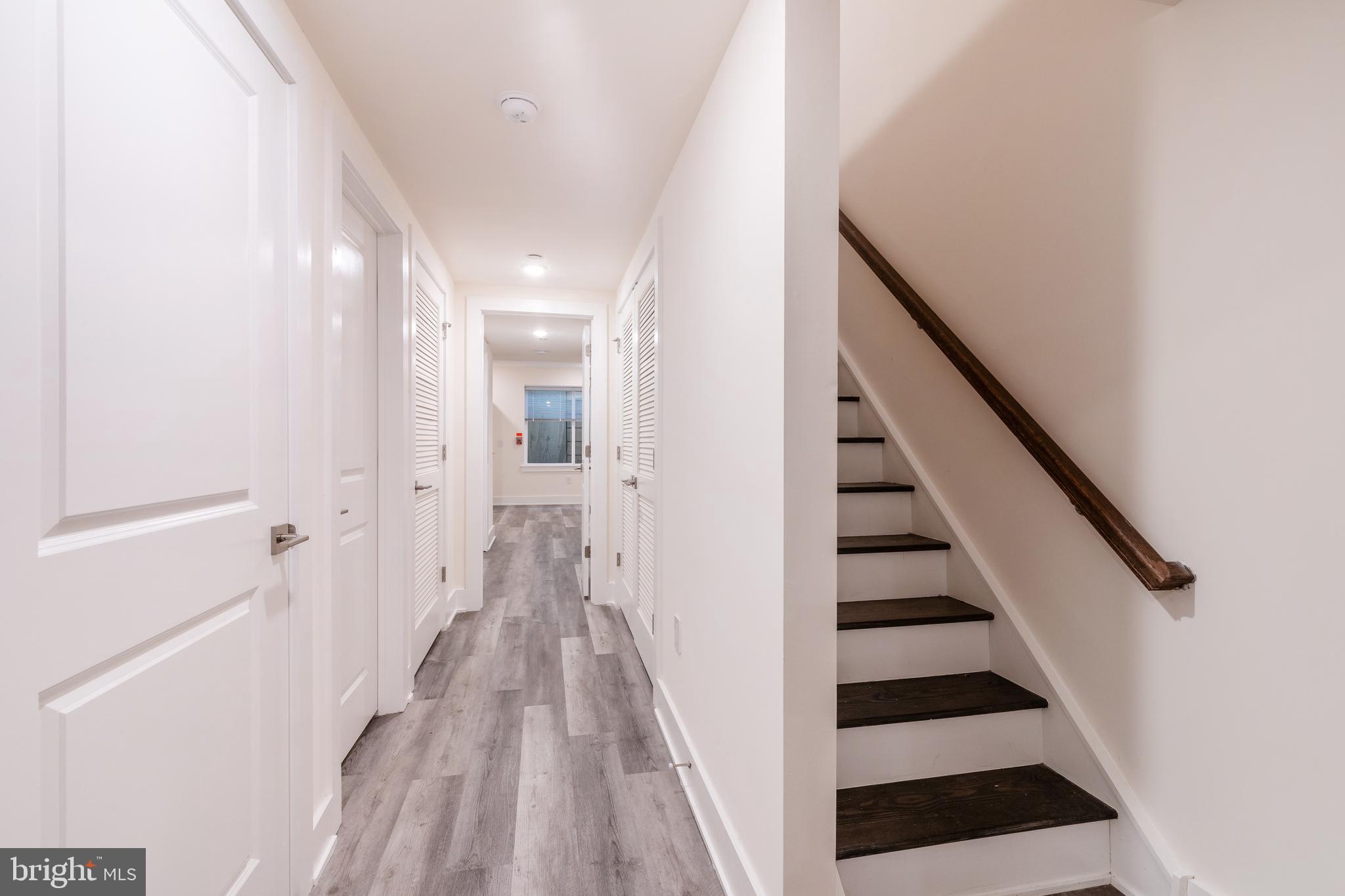 2612 Braddock Street, Unit 1 Philadelphia, PA 19125 - Photo 12 of 17 a view of a hallway with wooden floor and staircase