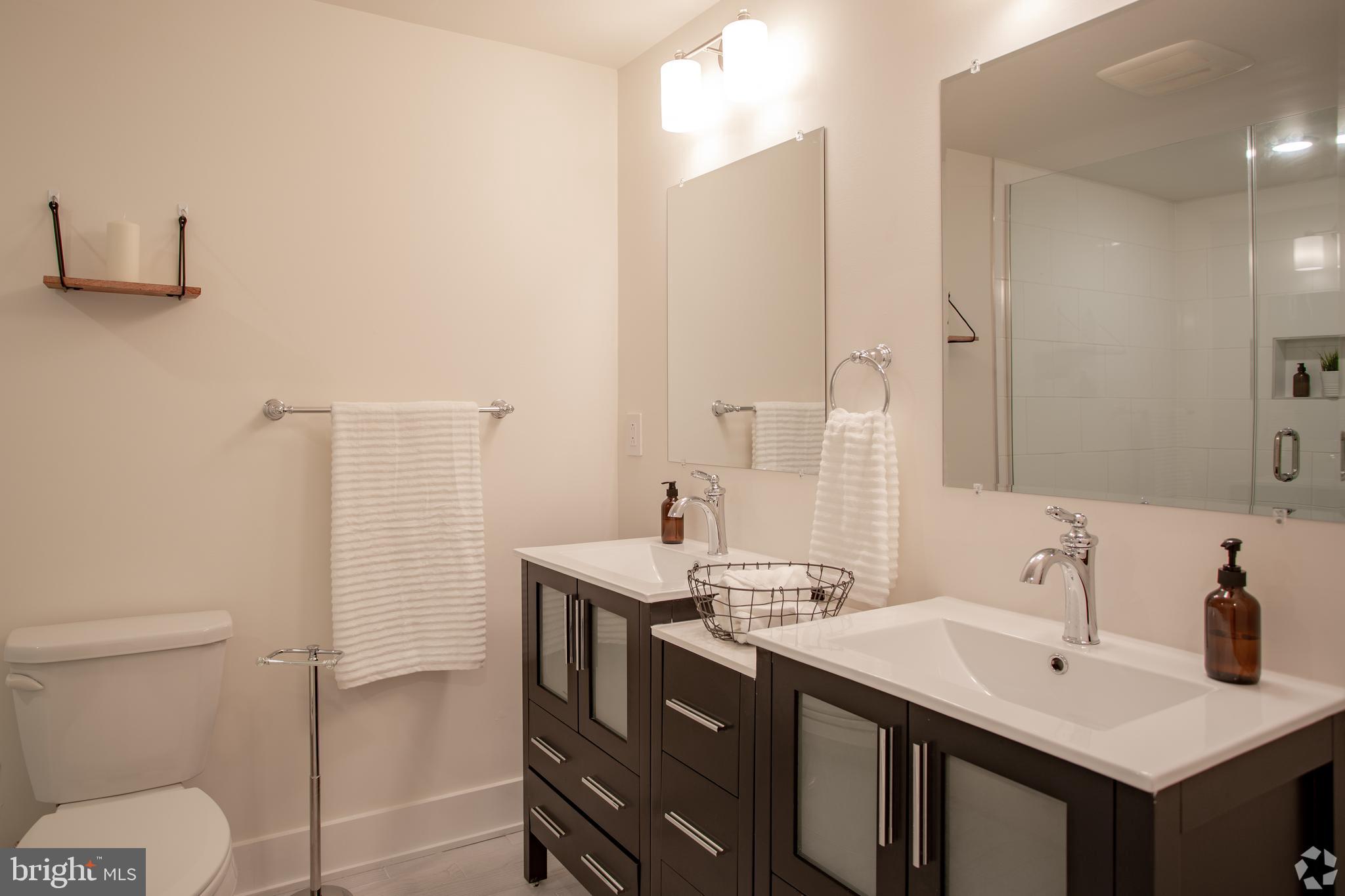 2612 Braddock Street, Unit 1 Philadelphia, PA 19125 - Photo 16 of 17 a bathroom with a sink toilet and mirror