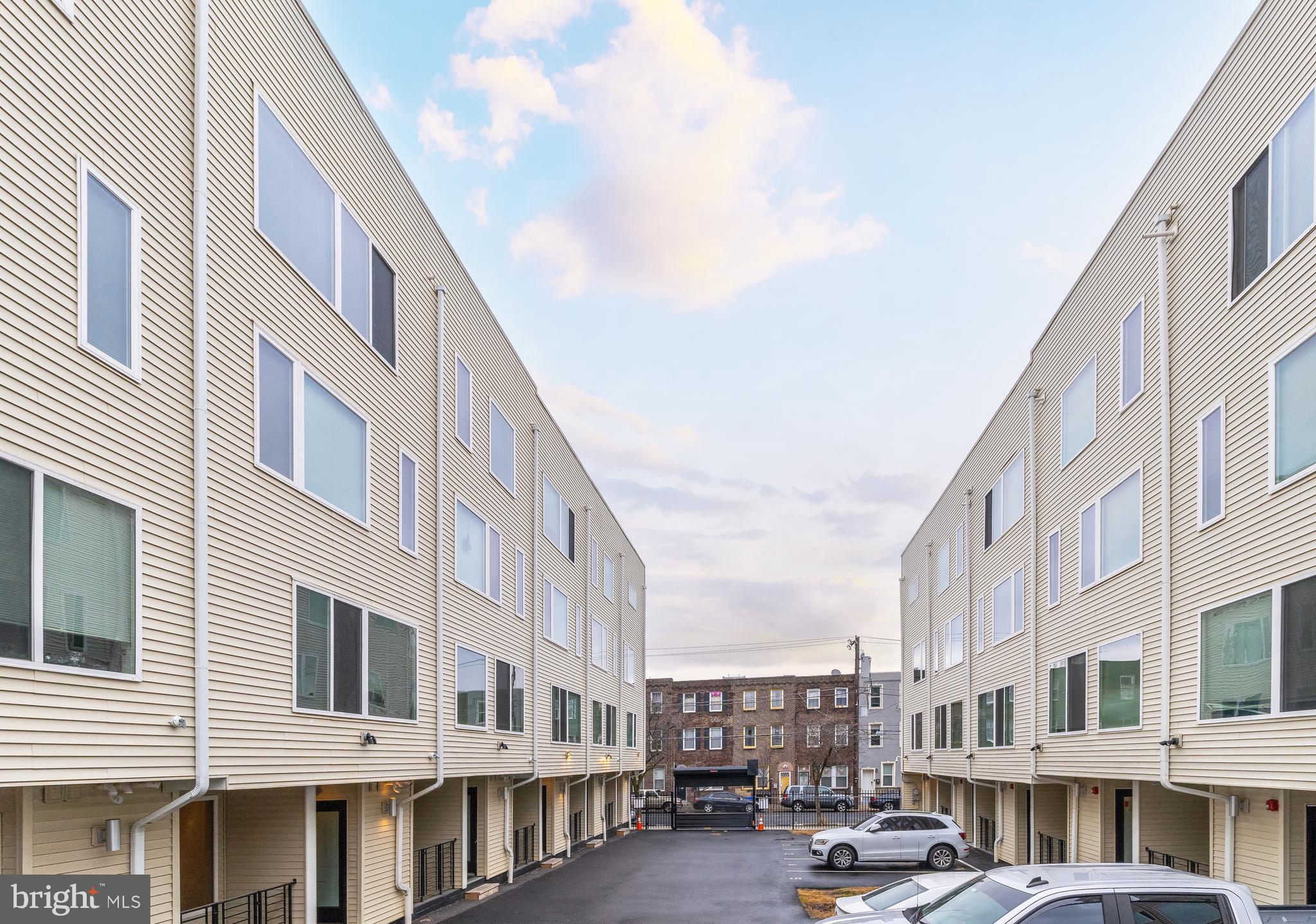 2612 Braddock Street, Unit 1 Philadelphia, PA 19125 - Photo 2 of 17 a front view of a building with lot of cars and trees