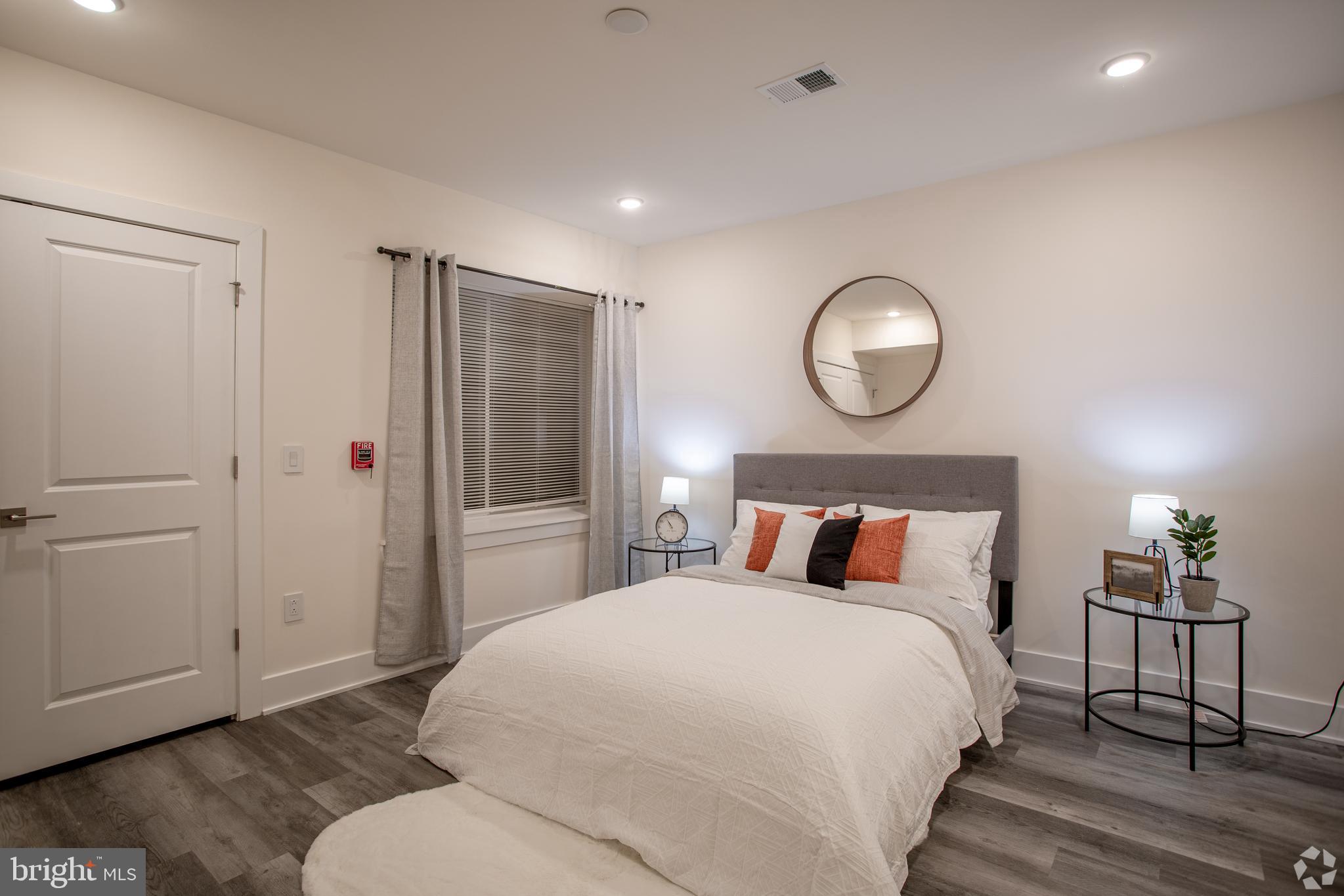 2612 Braddock Street, Unit 1 Philadelphia, PA 19125 - Photo 8 of 17 a bedroom with a bed and wooden floor